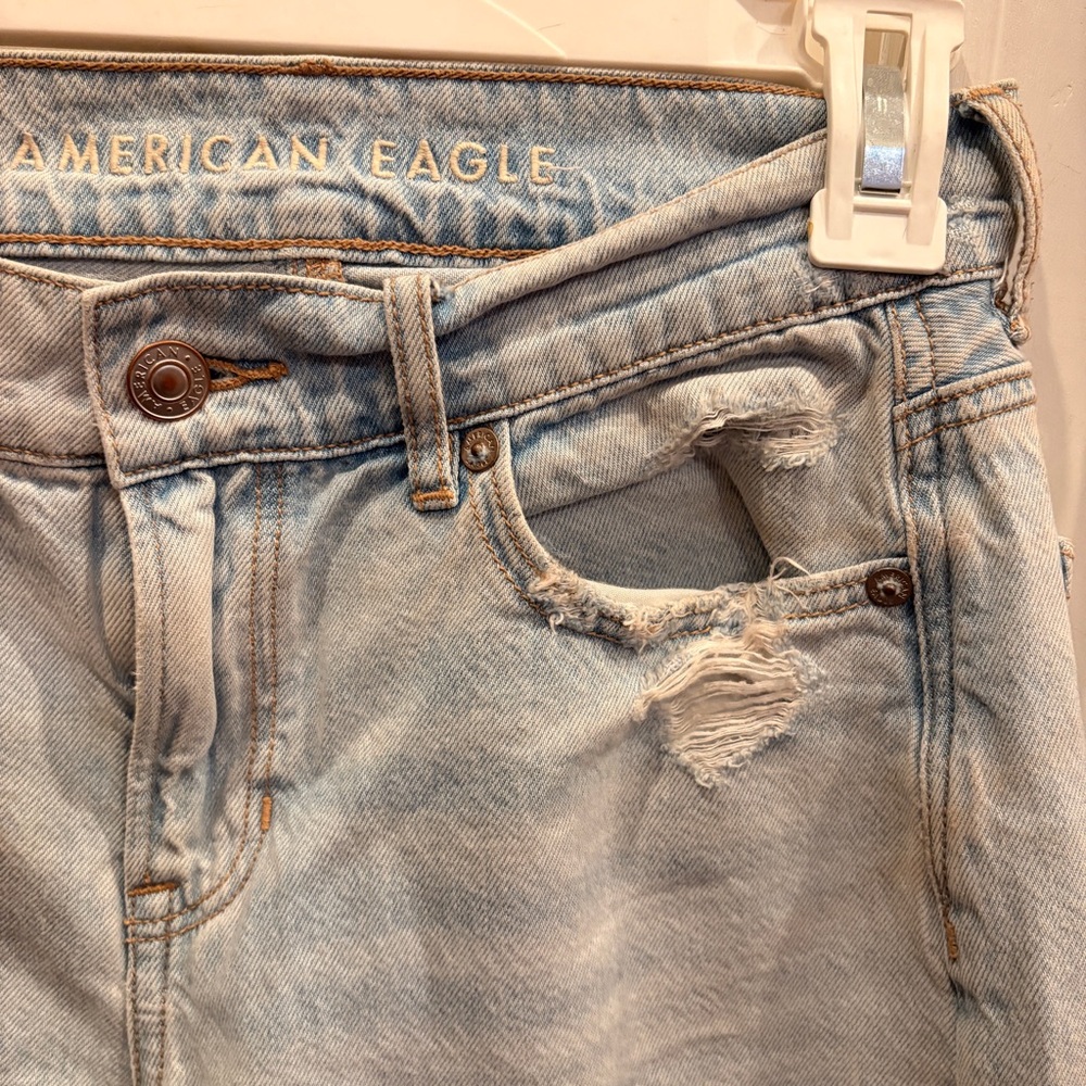 Mildly distressed light wash low rise baggy jeans